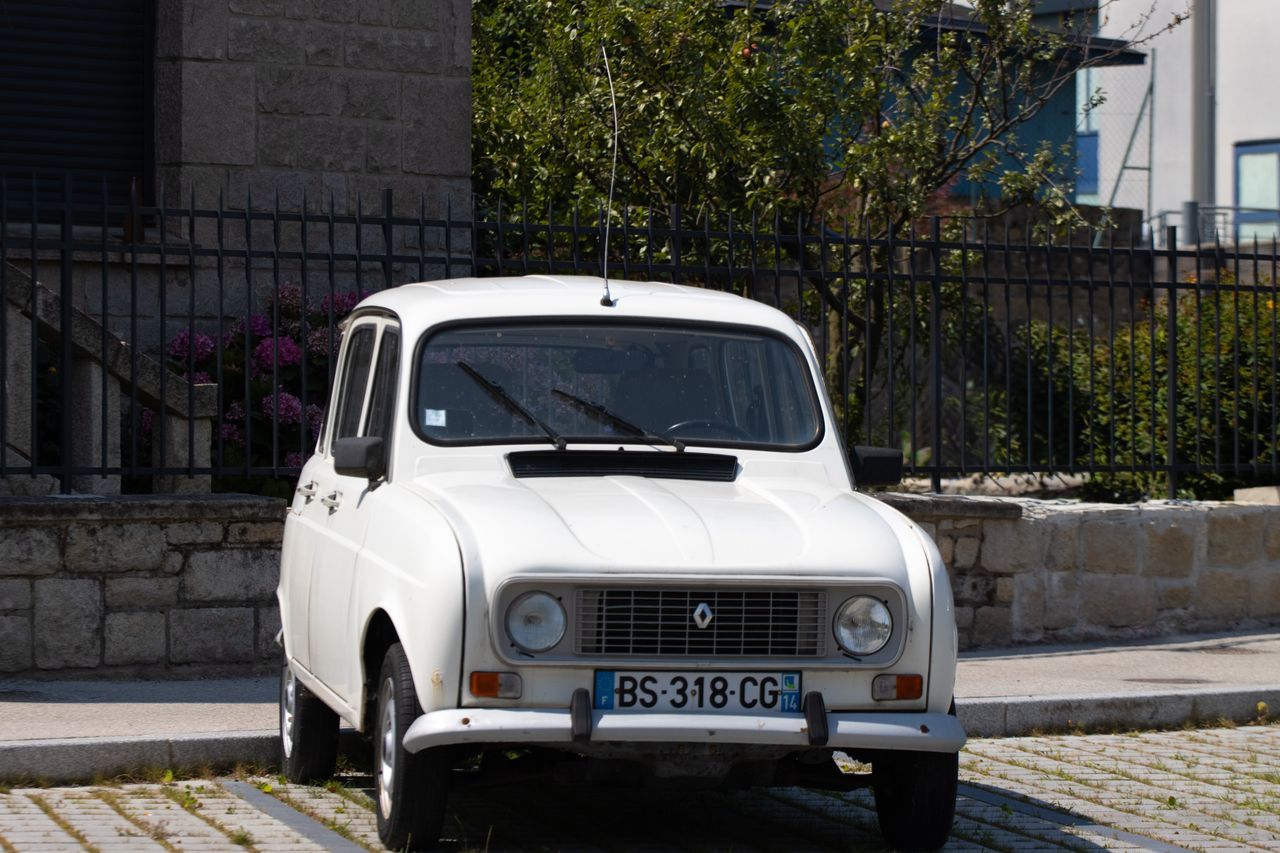 Vintage Renault car parked in Dol-de-Bretagne, Brittany, France on a sunny day.